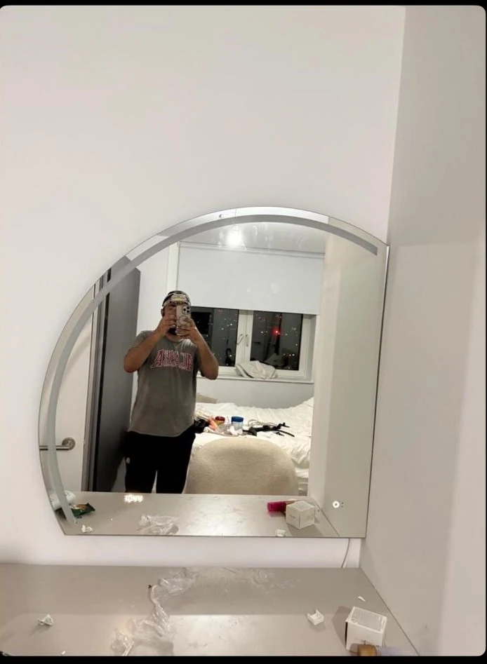 Large arched LED bathroom mirror mounted on the wall