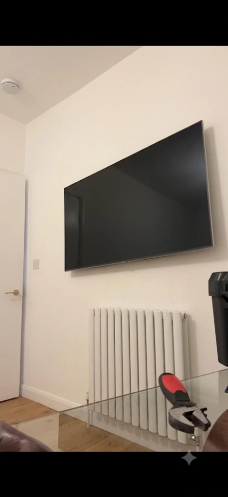 Large flat screen TV wall mounted with hidden cables in a living room